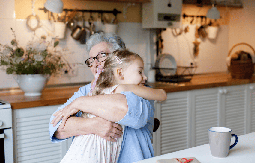 Child giving grandmother a hug