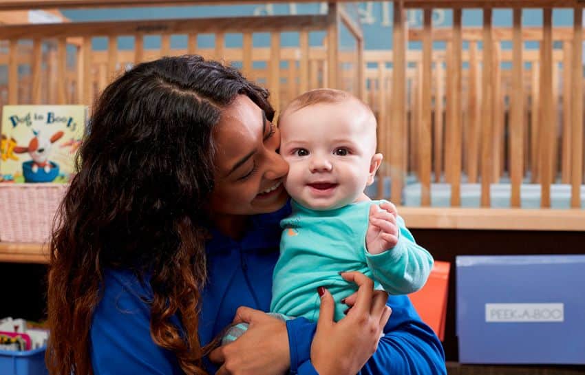 Infant Teacher Hugging Baby