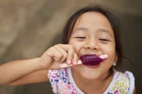 child enjoying a yogurt smoothie pop