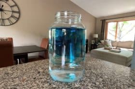 food coloring dilating in glass jar to make fireworks in a jar