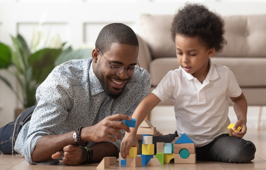 father and son playing with building blocks