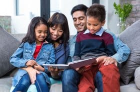 family reading a story together on the couch