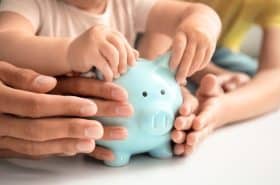 family holding piggy bank