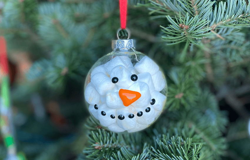 Marshmallow snowman ornament holiday craft hanging on Christmas tree