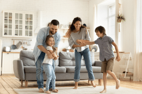 Family dancing in living room