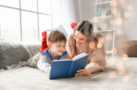 Mother and sun reading together on the floor