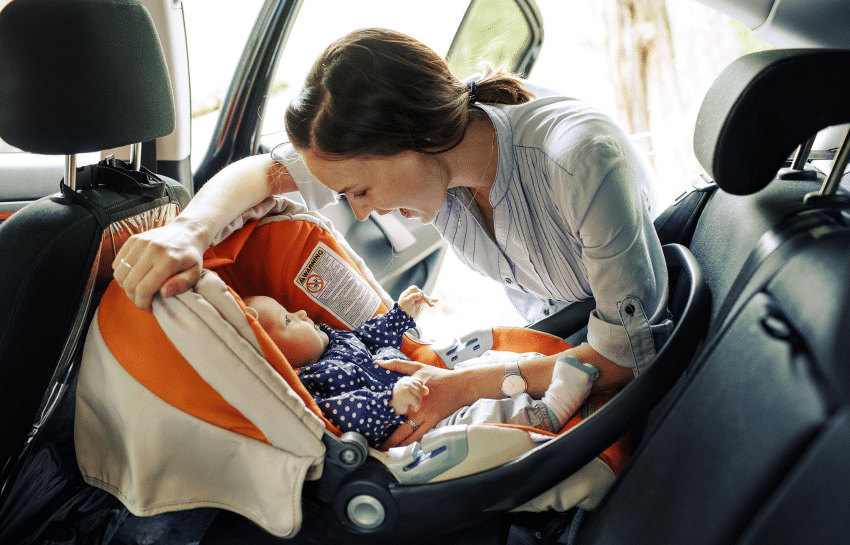 mother dropping infant off at daycare center