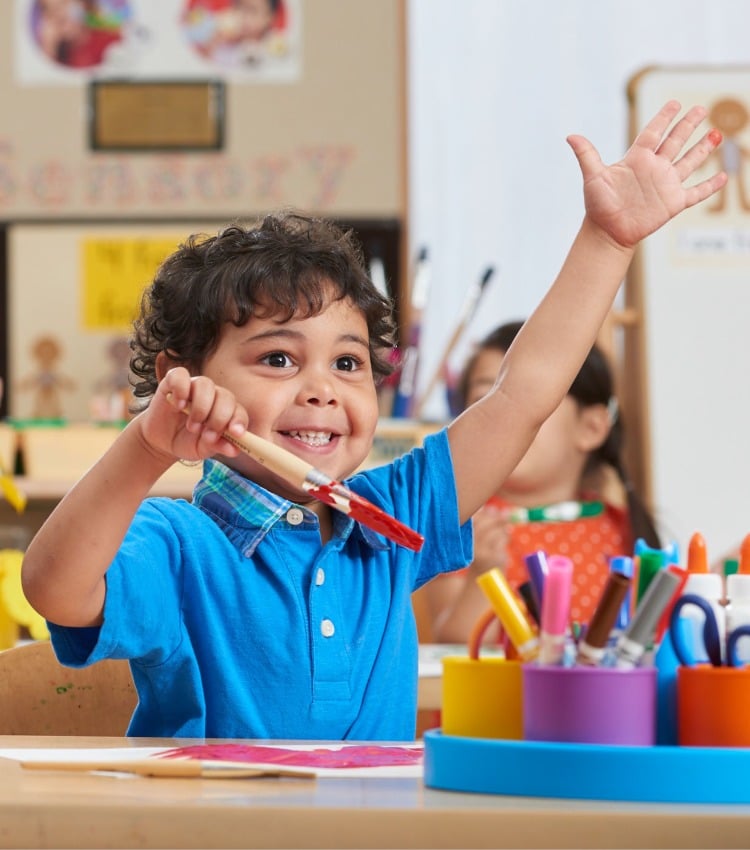 preschool student at New Horizon Academy enjoying an art project