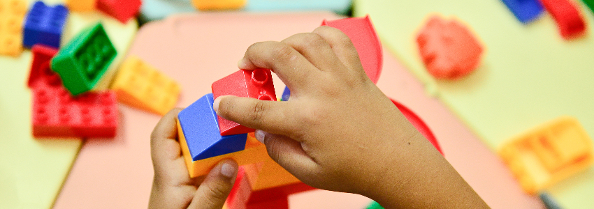 Child playing with legos for fine motor activity